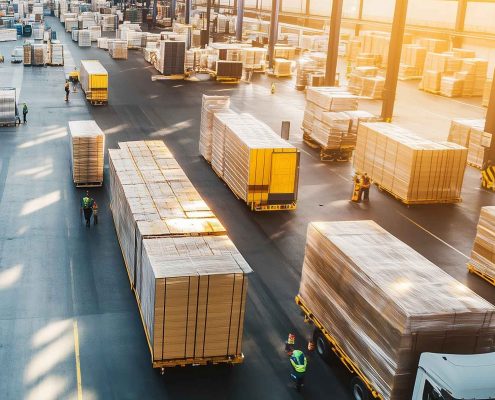 Office movers Melbourne — aerial view of a large commercial warehouse with trucks and forklifts managing logistics operations.