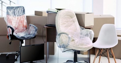 Office movers Melbourne — bubble-wrapped office chairs and furniture staged and ready for loading during an office relocation.