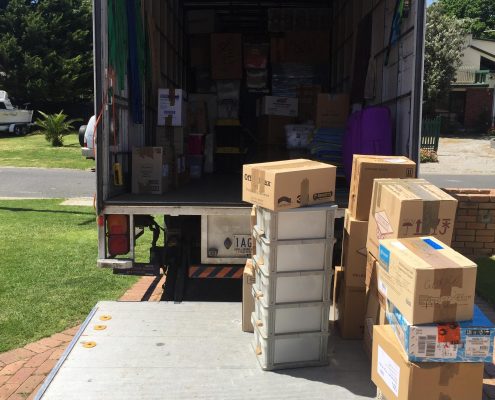 Office movers Melbourne — rear view of a fully loaded Jake Move truck packed with boxes and office items.